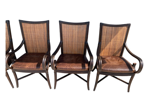 Palecek bamboo / woven bamboo back dining chairs leather seat and scrolled arms.