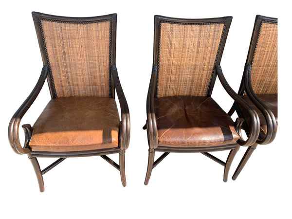 Palecek bamboo / woven bamboo back dining chairs leather seat and scrolled arms.