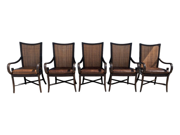 Palecek bamboo / woven bamboo back dining chairs leather seat and scrolled arms.