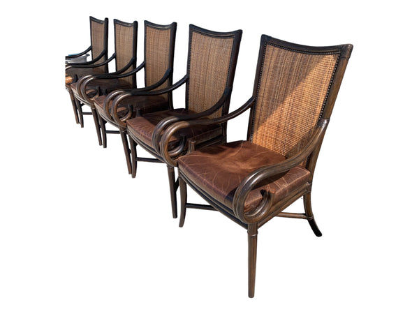 Palecek bamboo / woven bamboo back dining chairs leather seat and scrolled arms.