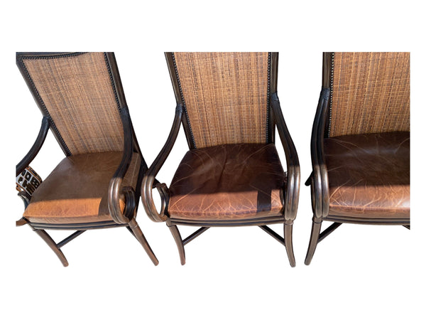 Palecek bamboo / woven bamboo back dining chairs leather seat and scrolled arms.