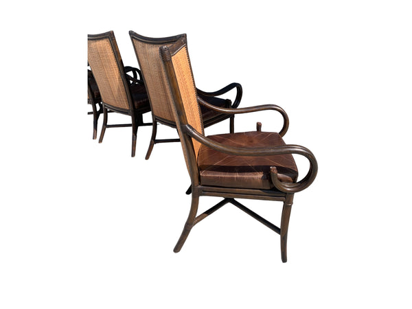 Palecek bamboo / woven bamboo back dining chairs leather seat and scrolled arms.