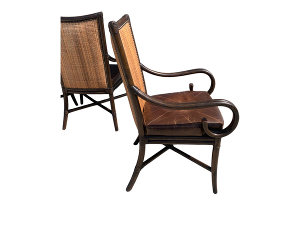 Palecek bamboo / woven bamboo back dining chairs leather seat and scrolled arms.